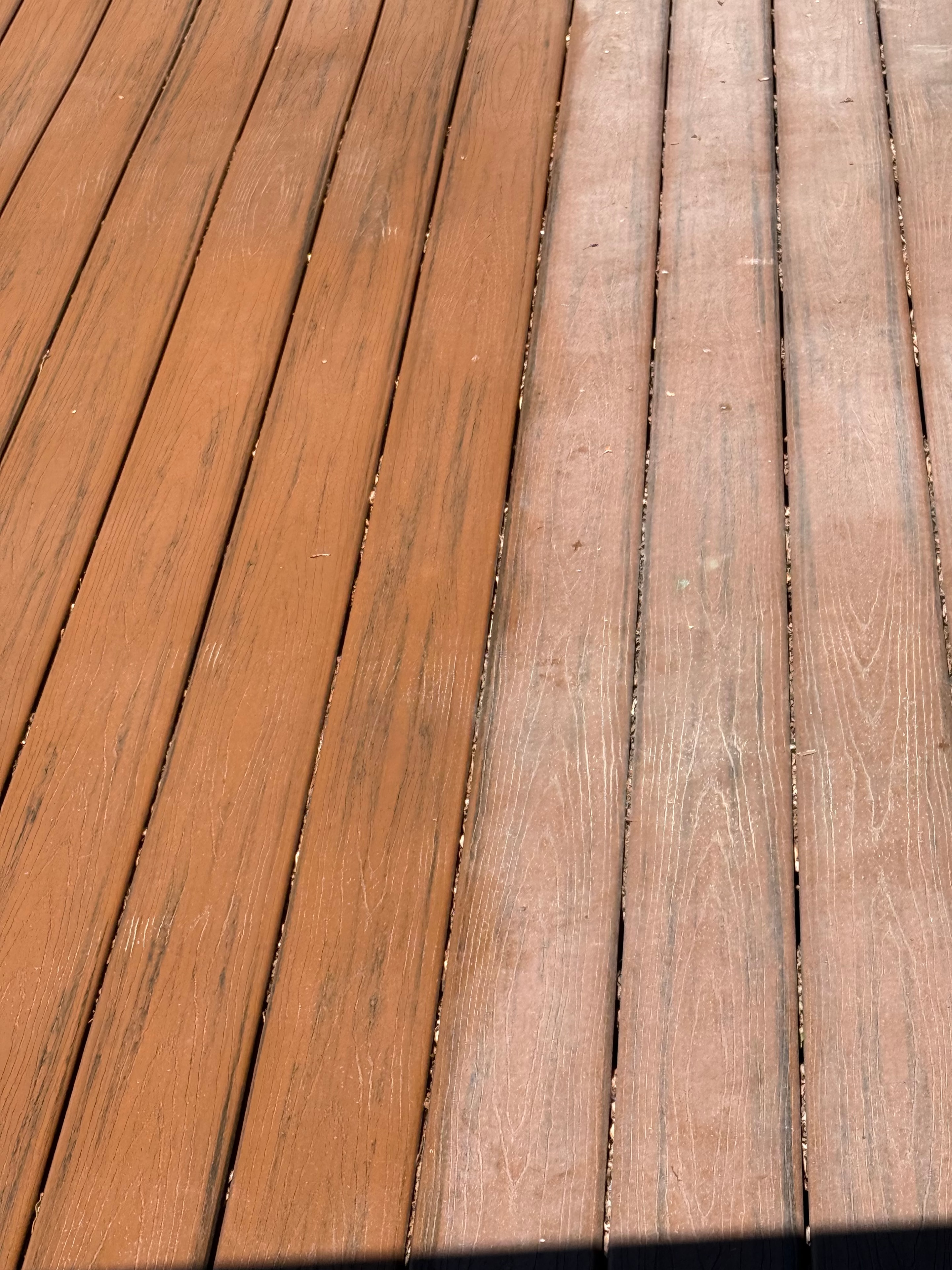Composite deck boards showing treated vs untreated areas